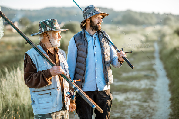 Grandfather with adult son going for fishing Stock Photo by RossHelen
