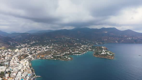 The Island of Crete From the Air From a Height of 500 Meters. City, Sea in Cloudy Weather View From