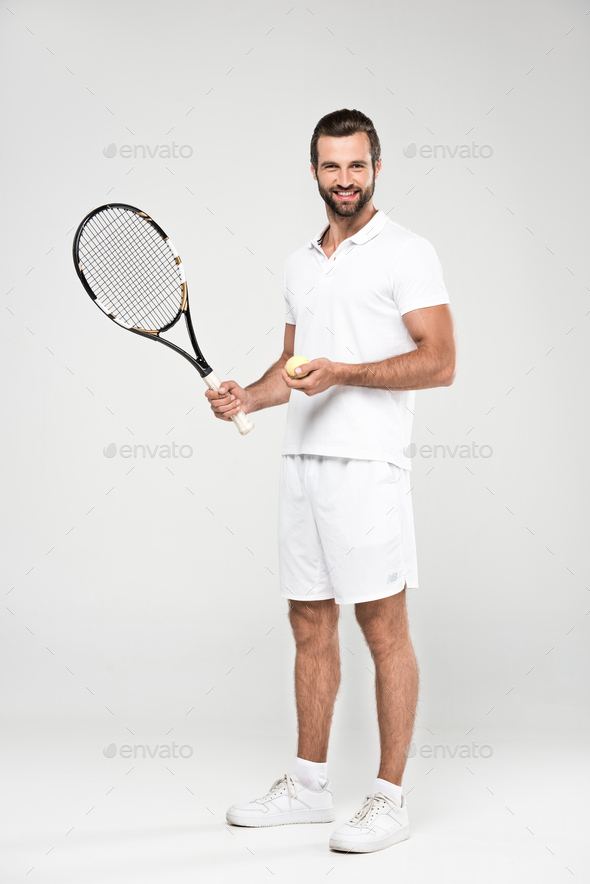 male tennis player with ball and racket, isolated on grey