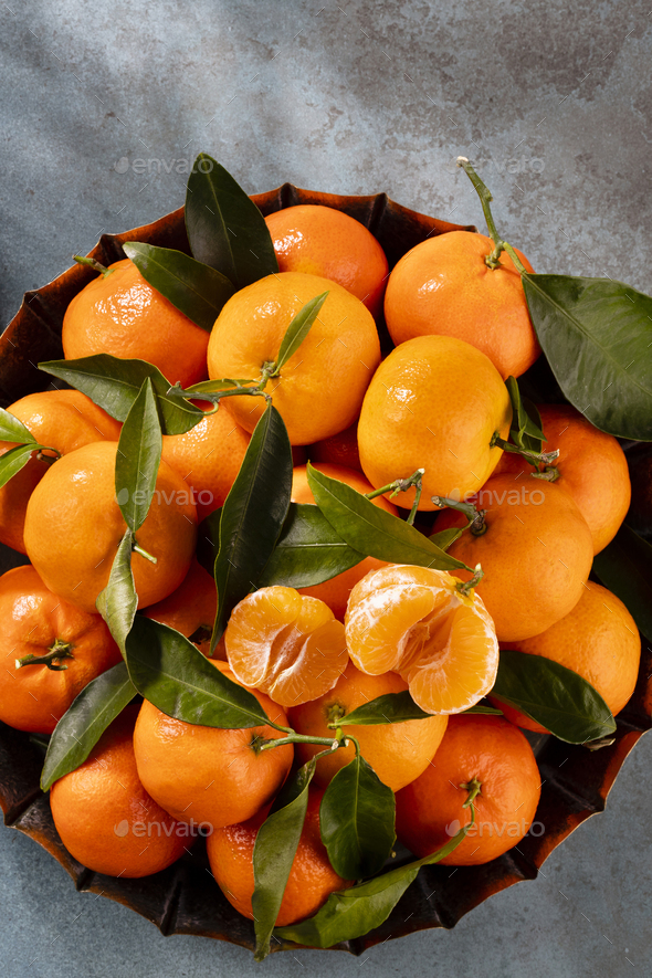 Fresh Clementine Mandarin Oranges fruits or Tangerines with leaves on  wooden background Stock Photo by nblxer