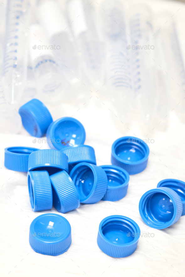 Used centrifuge tubes with blue caps for sample collection and preparation. Biochemical or
