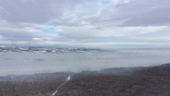 Air pollution over the city 4K aerial footage alt