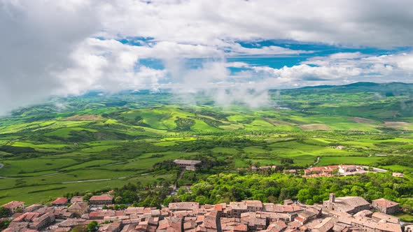 Time lapse aerial: unique green landscape in Orcia Valley, Tuscany, Italy. Scenic clouds moving by w alt