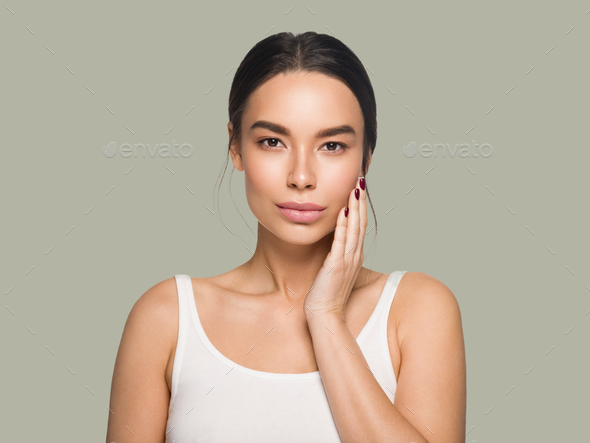 Asia beauty woman touching her face healthy skin  model portrait. Color background. Green - Stock Photo - Images