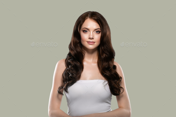 Beautiful hair skin woman portrait natural make up long curly hair. Color background green