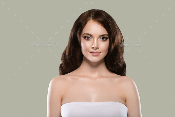 Beautiful hair skin woman portrait natural make up long curly hair. Color background green