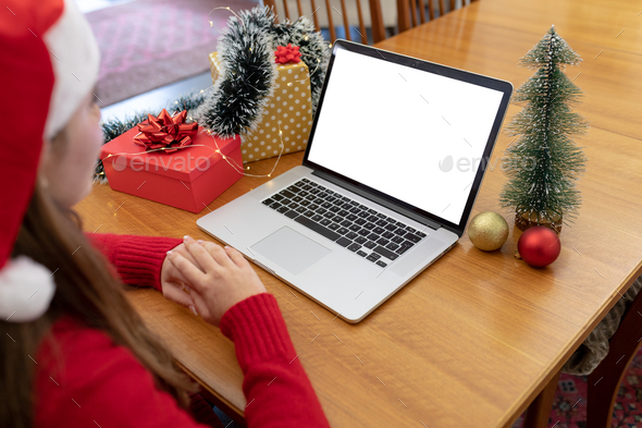 Caucasian woman wearing santa hat having video call on laptop with copy space at christmas time - Stock Photo - Images