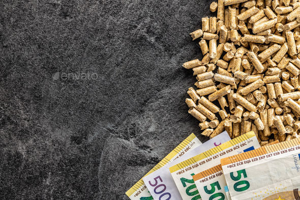 Wooden pellets and euro banknotes. Ecological heating.
