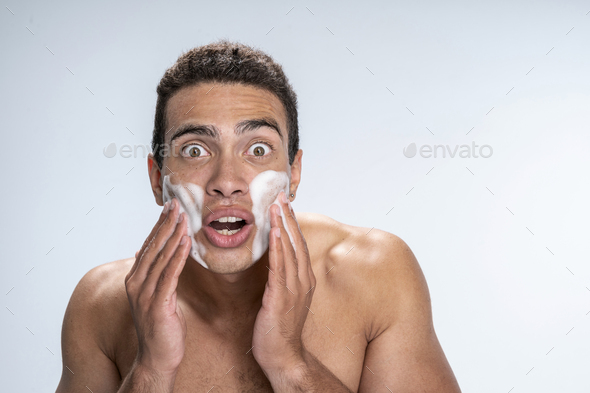 Man being amused at the effect of cosmetics