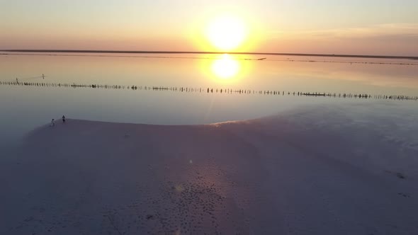 Aerial Short  of Surface Covered with White Sand at Black Sea Coast at Sunset  alt