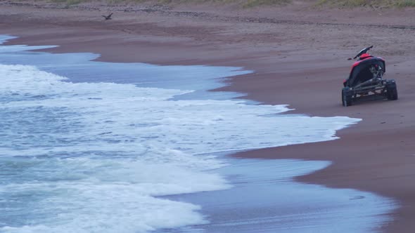 Rred jet ski on the trailer at the Baltic sea sandy beach, medium shot alt