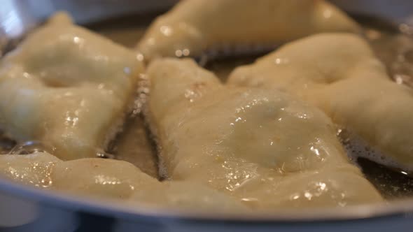 Tasty fried buns in hot oil  popular snack preparing 3840X2160 UltraHD footage - Close-up of frying  alt