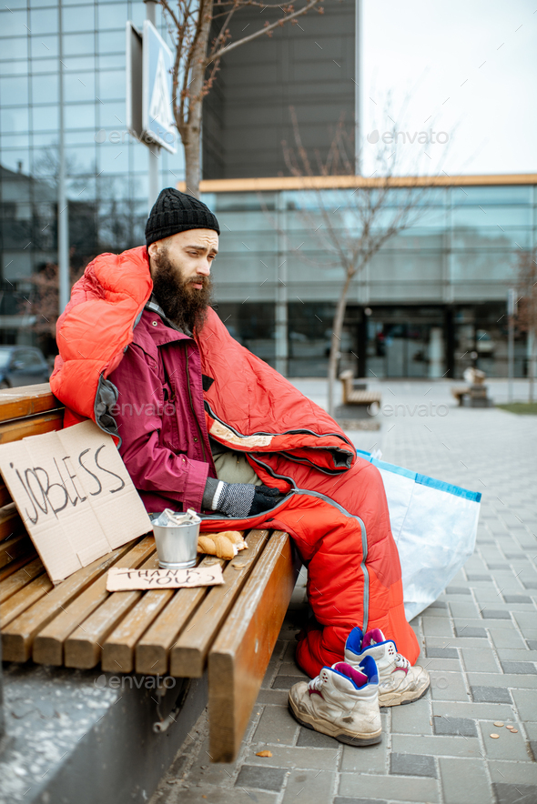 Homeless beggar on the bench near the business center Stock Photo by ...