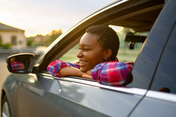 Beautiful young girl posing at camera for photo in car on street Stock  Photo by ©sisterspro 141008820