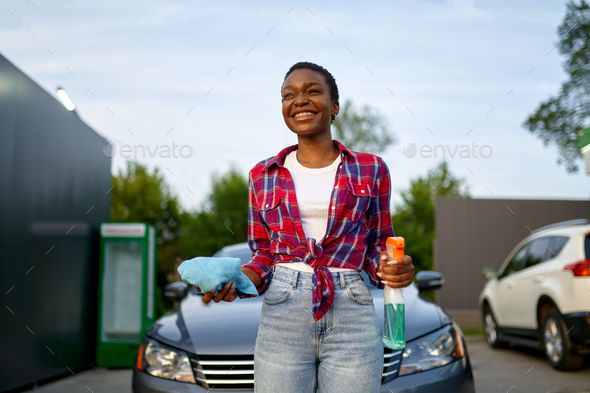 Beautiful flirtatious woman poses next to classic car Stock Photo - Alamy