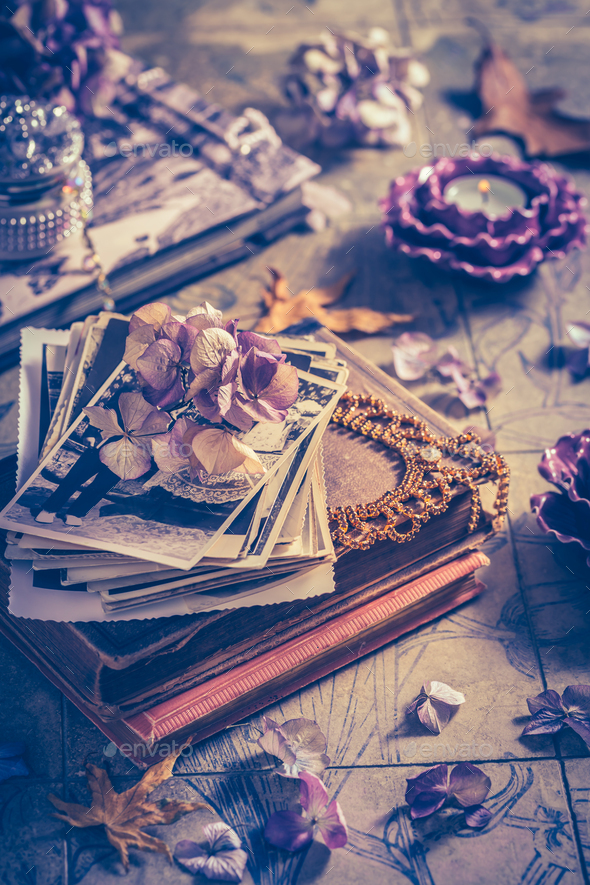Memories - old family photo album with necklace, old books and dried flowers