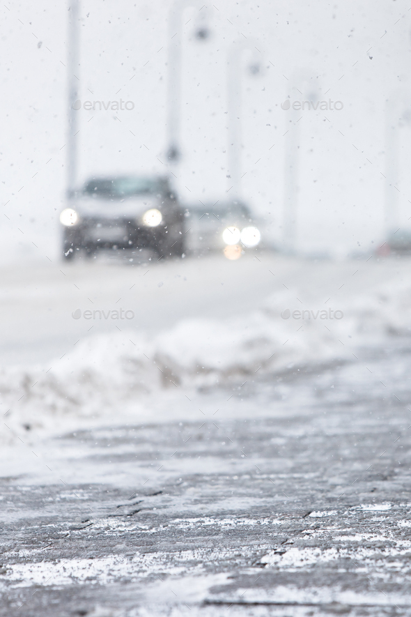 Deicing chemicals in winter, pavement sprinkled with reagent. Technical salt will make road