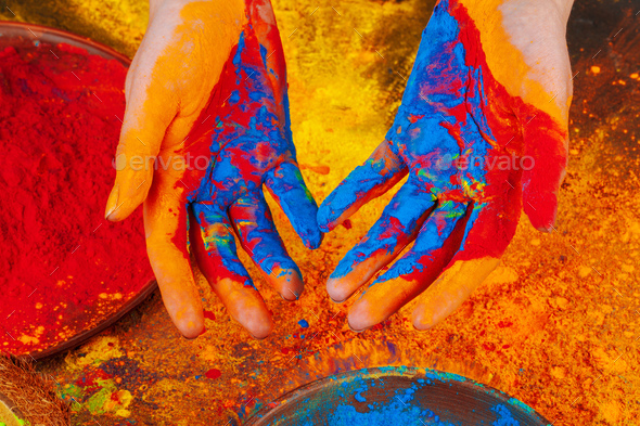 Hands holding Holi powder paint, view from above