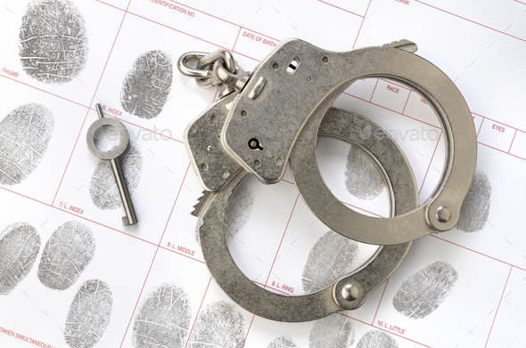Handcuffs on fingerprint sheet - Stock Photo - Images