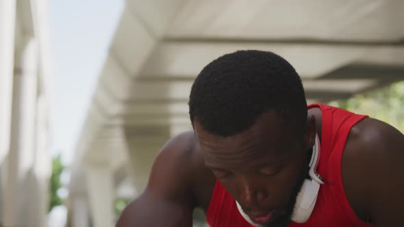 Man training in an urban setting taking a break alt