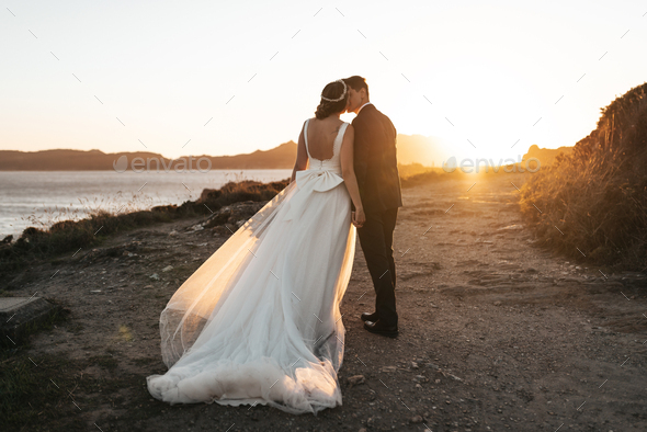 Just married couple kissing near the ocean - Stock Photo - Images