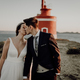 Moody portrait of a just married couple against a lighthouse - PhotoDune Item for Sale