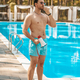 Male lifeguard warning visitors about emergency situation Stock Photo by  Zinkevych_D