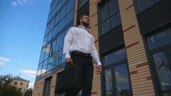 Successful Businessman with Briefcase Walking at Urban Street alt