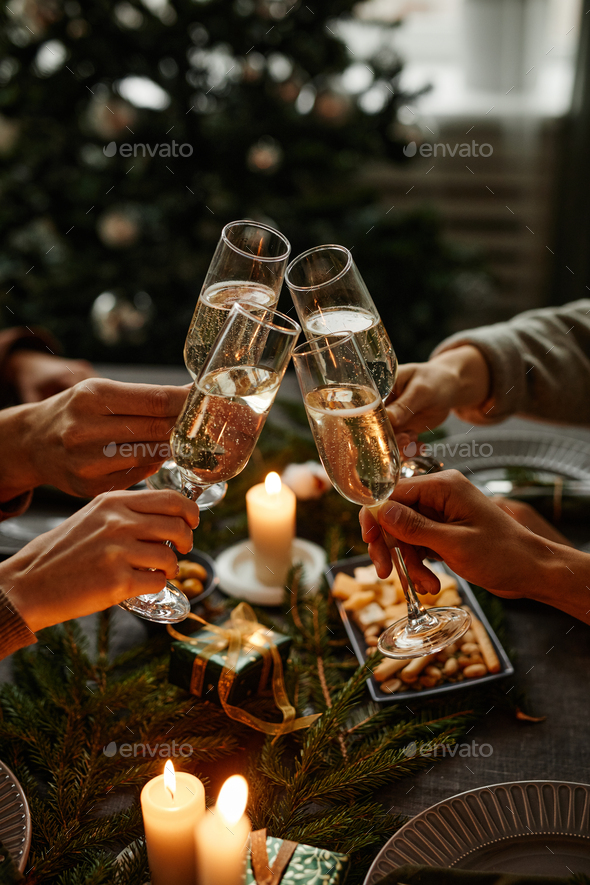 Close Up Glasses Of Clinking Glasses Of Champagne With Lighting