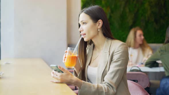 Business Woman with Orange Juice in Cafe