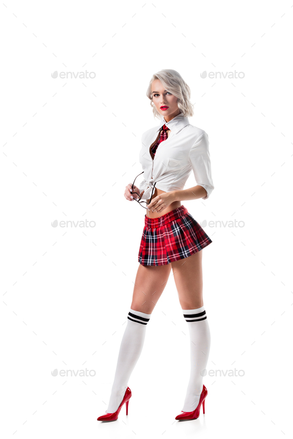 sexy young woman in short schoolgirl plaid skirt and knee socks with eyeglasses posing isolated on