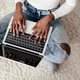 cropped image of african american woman using laptop on floor at home - PhotoDune Item for Sale