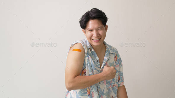 Handsome asia hipster male after shot receive covid-19 anti virus vaccine