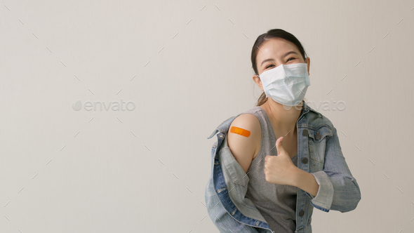 Young attractive beautiful asia female or teenage receive covid-19 anti virus vaccine