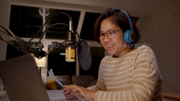 Asian Female Podcaster Recording And Broadcasting Her Podcast From Home