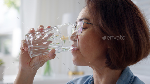 Close-up asia elder people or latin lady hold clean spring cold alkaline water