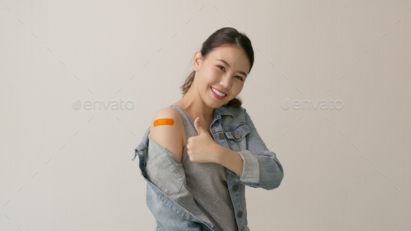 Young attractive beautiful asia female or teenage receive covid-19 anti virus vaccine