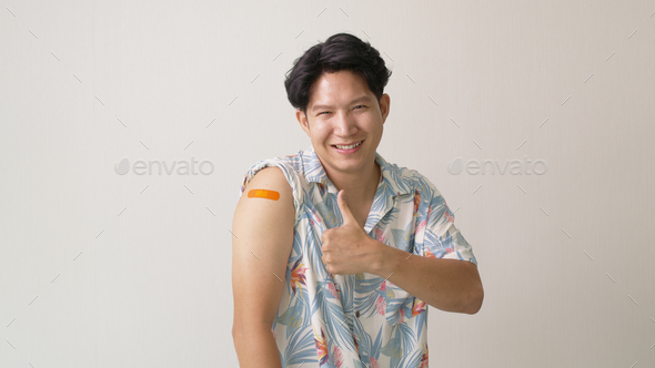Adult mature attractive handsome asia hipster male after shot receive covid-19 anti virus vaccine