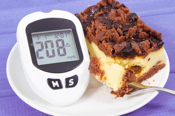 Glucose meter with high and bad result sugar level and fresh baked homemade cheesecak