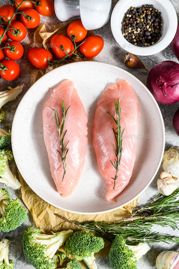 Turkey fillet. Farm poultry breast meat. Gray background. Top view