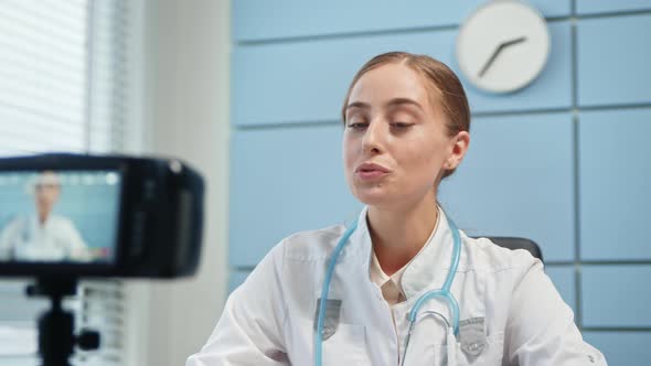Amazed lady blogger in medical coat talks alt