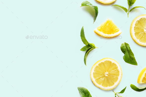 Top view of citrus slices and mint herbs frame on retro mint background - Stock Photo - Images