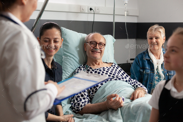 Physician woman doctor discussing healthcare treatment with elderly sick grandfather
