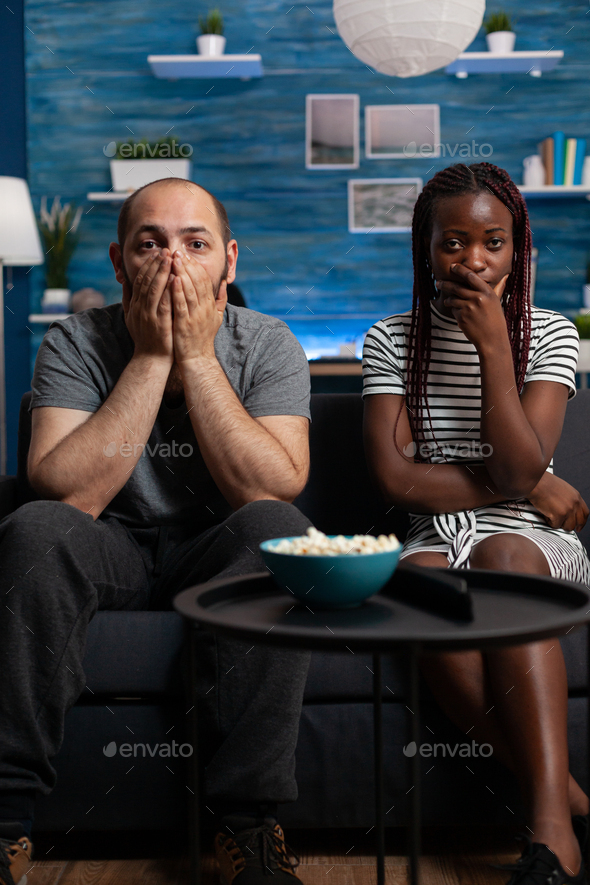 POV of interracial couple being shocked watching drama movie