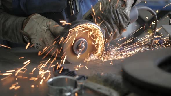 Workman Cutting A Metal With Grinder. Worker's Hands Cutting With Grinder.