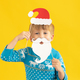 Happy child holding Santa Claus hat and beard - PhotoDune Item for Sale