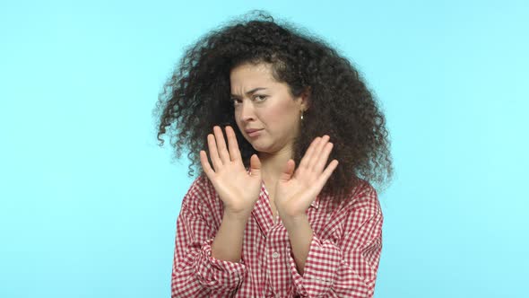 Slow Motion of Awkward Young Woman with Curly Hair Raising Eyebrows Shocked Cover Eyes From