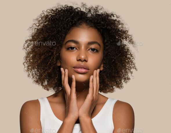Beautiful african woman white t-shirt portrait afro haircut touching her face Color background brown - Stock Photo - Images