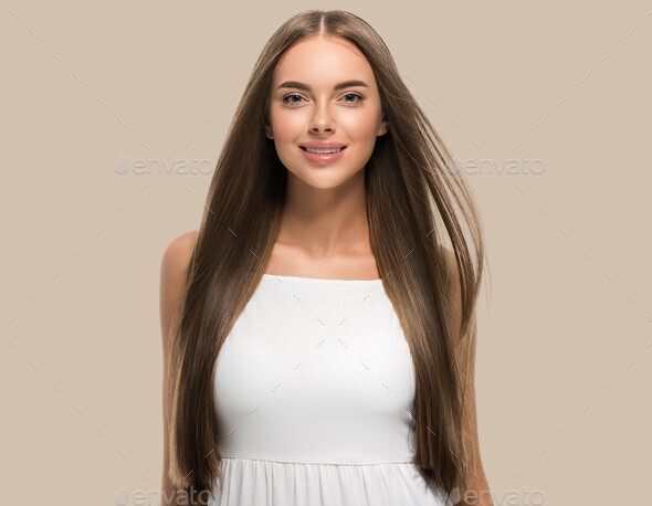 Beautiful woman with beautiful long smooth flying hair in white dress over color background - Stock Photo - Images