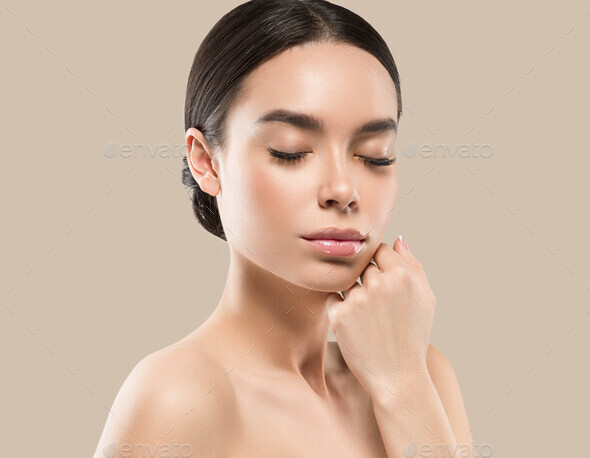 Asia woman beauty face body portrait touching her face healthy skin. Color background. Brown - Stock Photo - Images